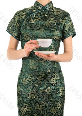 Woman in Chinese dress holding a cup of tea