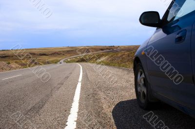 car in prairie road