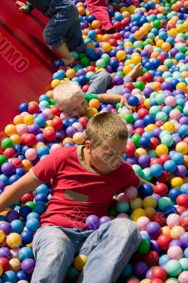 Boys playing in colourful ball pool
