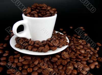 A coffee mug full of coffee beans