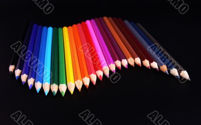 Color pencils wave isolated on black