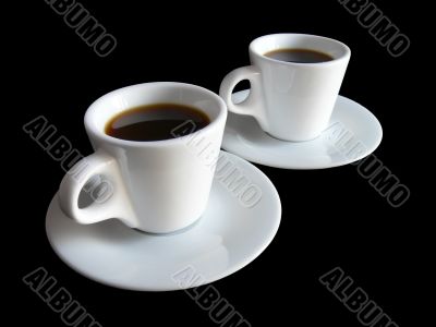 Two cups of coffee on black
