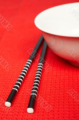 Pair of chopsticks and white bowl