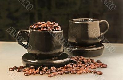Two cups and coffee beans