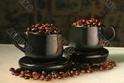 Two cups and coffee beans