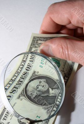 Magnifying glass and dollar