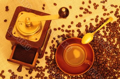 Cup of coffee with mill and beans
