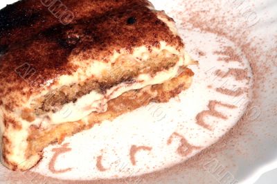 tiramisu dessert served on plate with cacao decoration