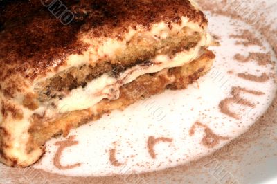 tiramisu dessert served on plate with cacao decoration