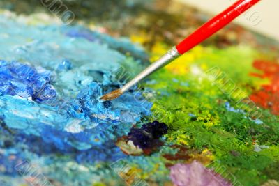 small painbrush is mixing colors
