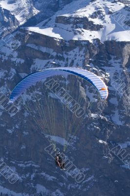 A close-up of a hovering paraglider