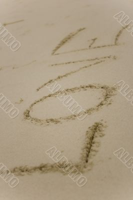 Love handwritten on the sand