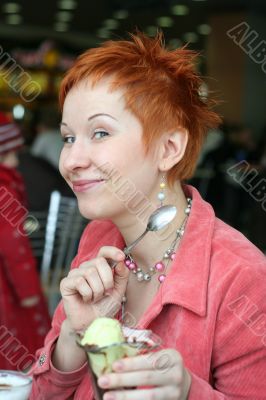 woman eating ice cream in cafe and smiling happy