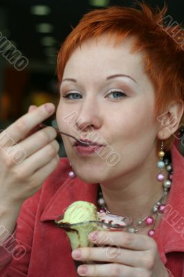 woman eating ice cream in cafe and smiling happy