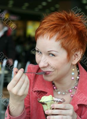 woman eating ice cream in cafe and smiling happy