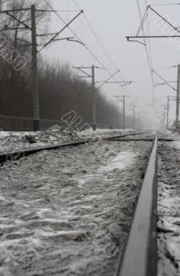 Dirty snow on raiway tracks.