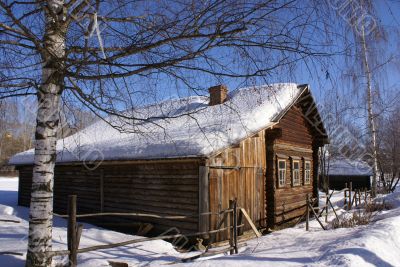 Old wooden house in snow