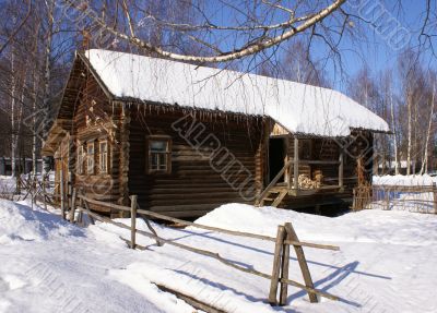 Old wooden house in snow