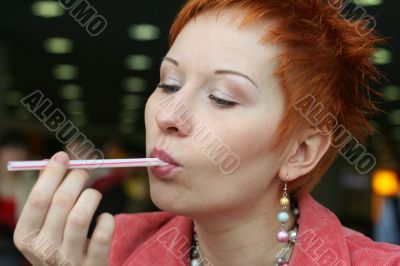 woman is licking a tubule in cafe and smiling happy