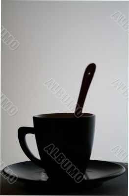 Black cup with a spoon