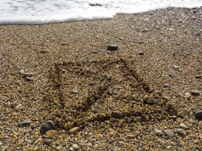 envelope on wet sea sand