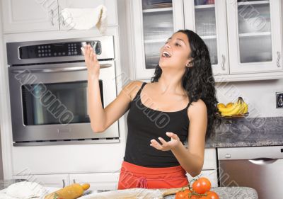 woman tossing pizza dough