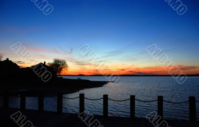 Lake house silhouette at the sunset