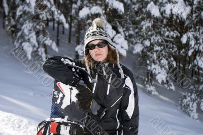 Beautiful girl snowborder in mountain