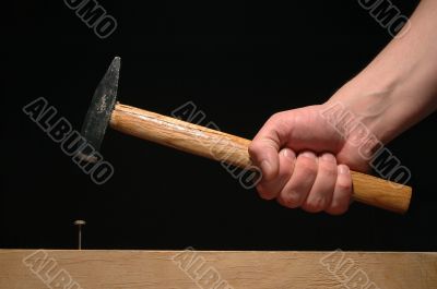Man’s hand holding hammer