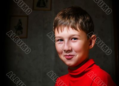 Smiling boy in dark room