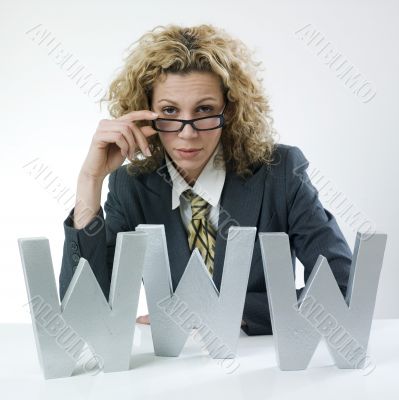 Businesswoman peering over glasses