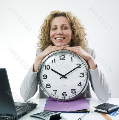Smiling woman with clock