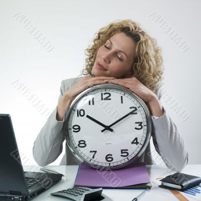Sleepy woman with large clock