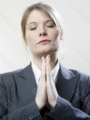 Praying businesswoman