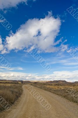 Lonely road under cloudy sky