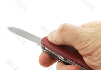 hand with a penknife isolated on white