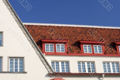 white house with tiled roof and blue sky