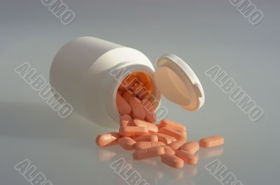 Medicine pills with a white bottle
