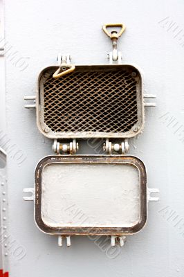window - the grate slatted porthole at a military ship