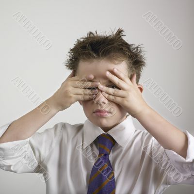Boy covering his eyes
