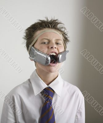 Boy shouting with two phones