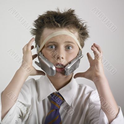 Stressed boy with phones