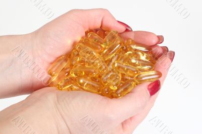 Woman`s hands holding gold boluses