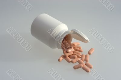 Medicine pills with a white bottle