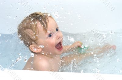 Excited boy in bathing waters