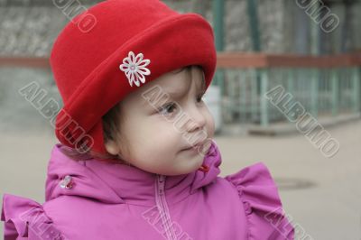 Little smiling girl in red hat