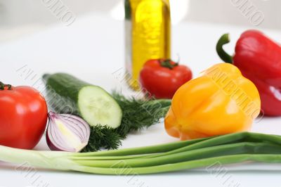 Multi-coloured vegetables for salad on a white background