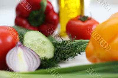 Multi-coloured vegetables for salad on a white background