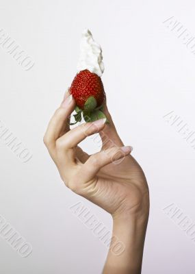 Hand holding strawberry