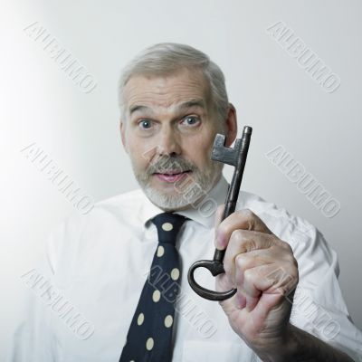 Businessman holding large key